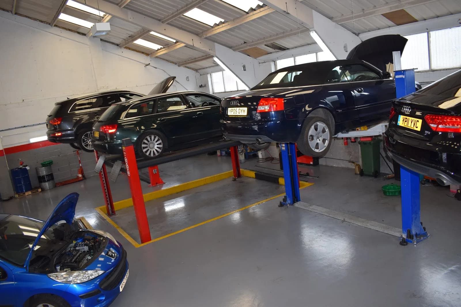 Cars raised on hydraulic ramps inside The Garage Sheffield workshop